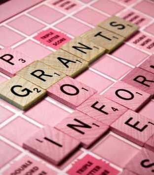 Grants written on scrabble board.